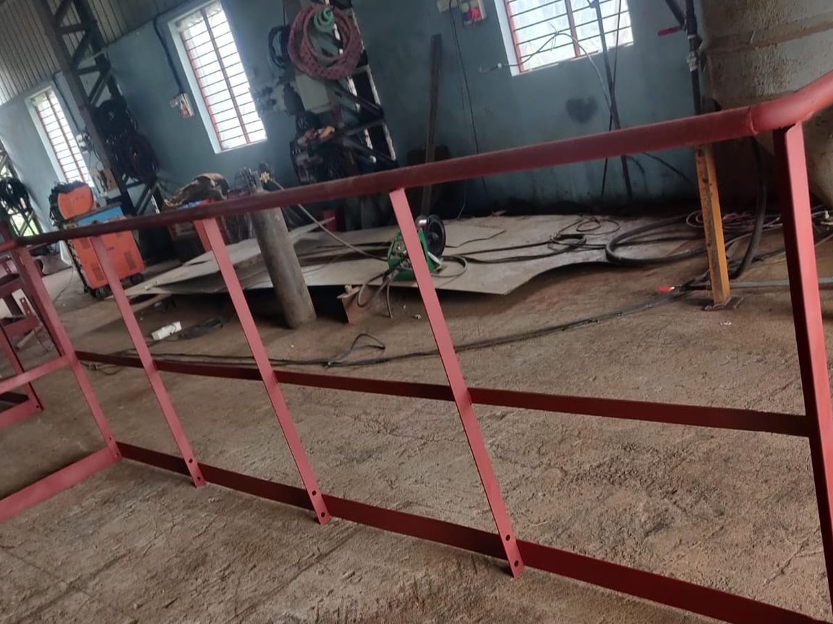 Fabricated steel access railing finished in red industrial paint