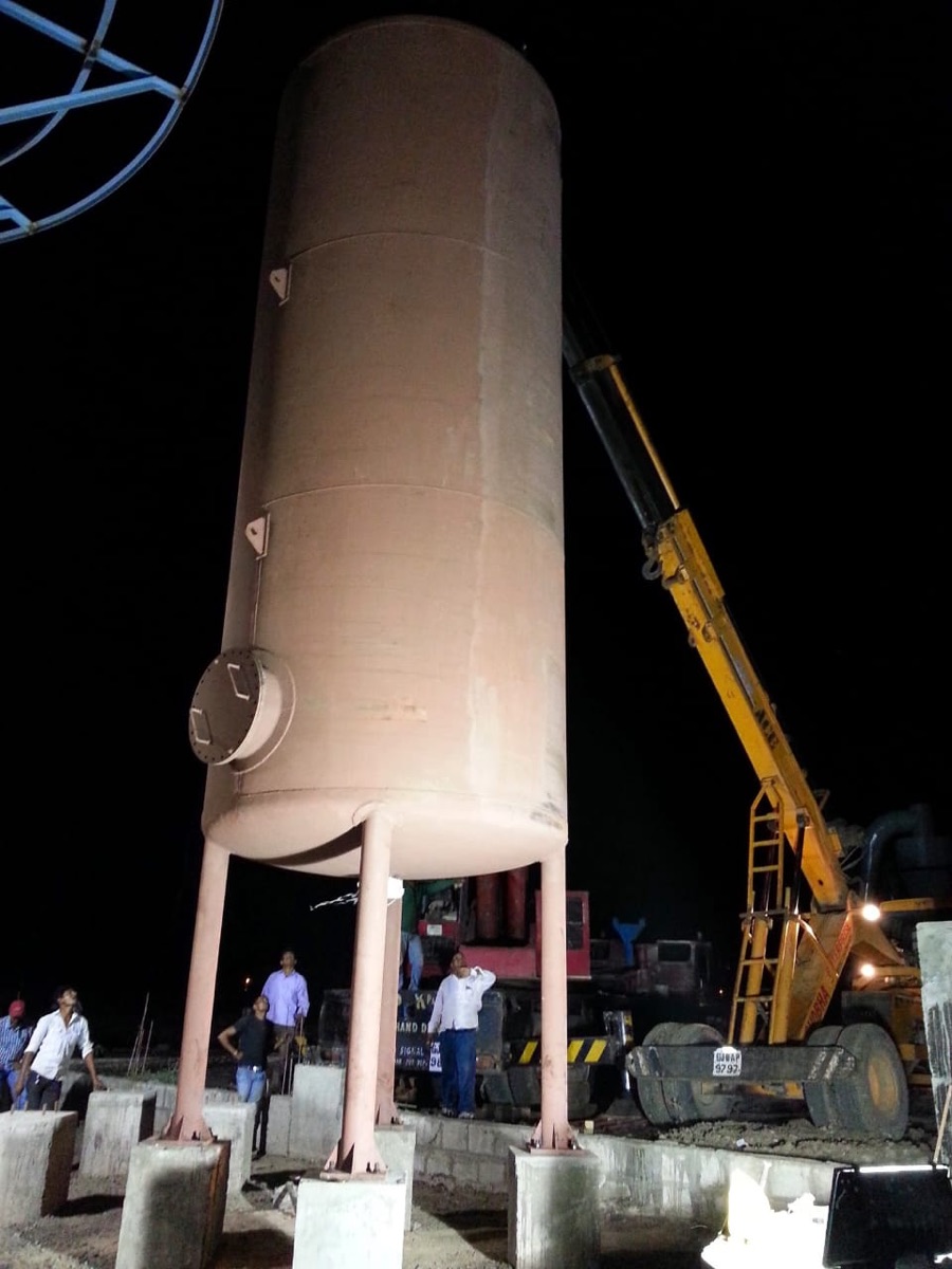 Vessel being erected onto its support legs by crane at night to hold the project schedule